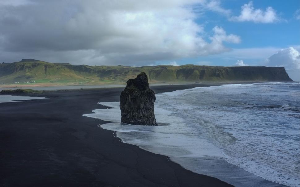 Free Image of Black Beach With Rock in Water 