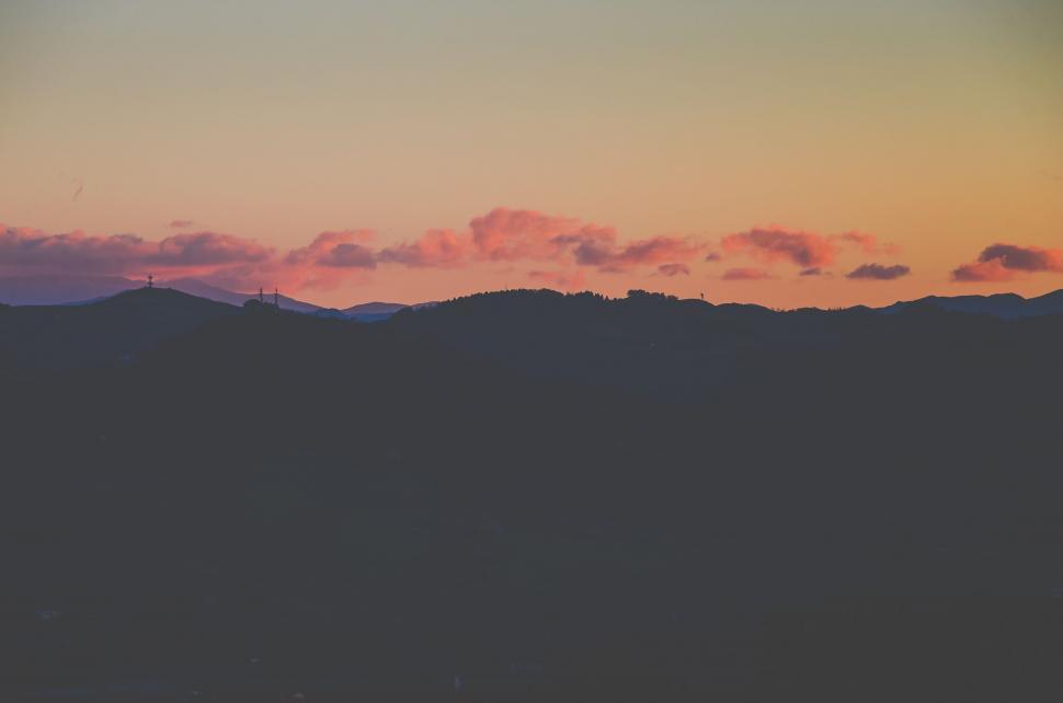 Free Image of Plane Flying Over Mountain at Sunset 
