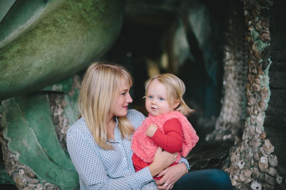 Free Image of Woman Holding Small Child in Her Arms 