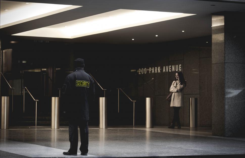 Free Image of Man Standing in Front of Tall Building 