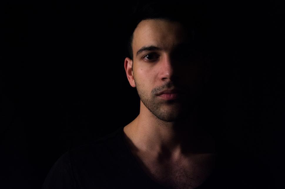 Free Image of Man Standing in the Dark 