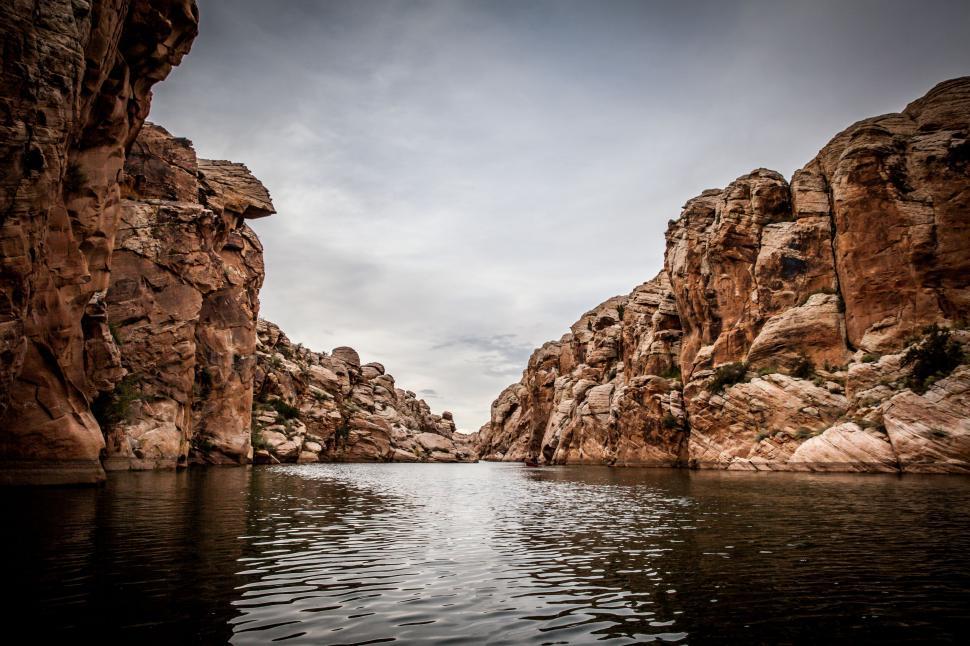 Free Image of Vast Water Body Encircled by Rocks 