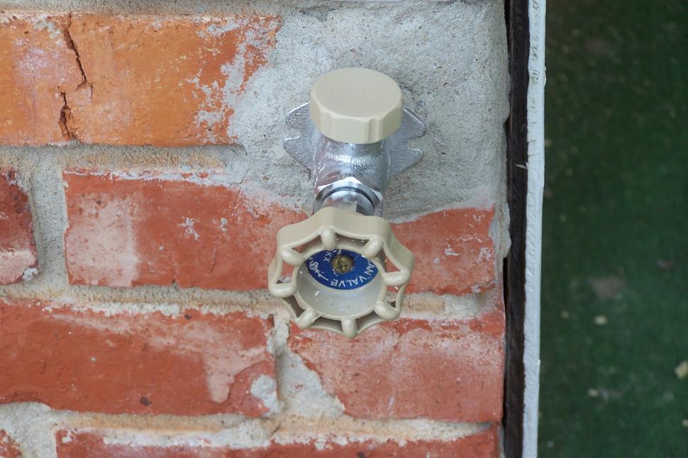 Free Image of Outdoor Water Faucet on Brick 
