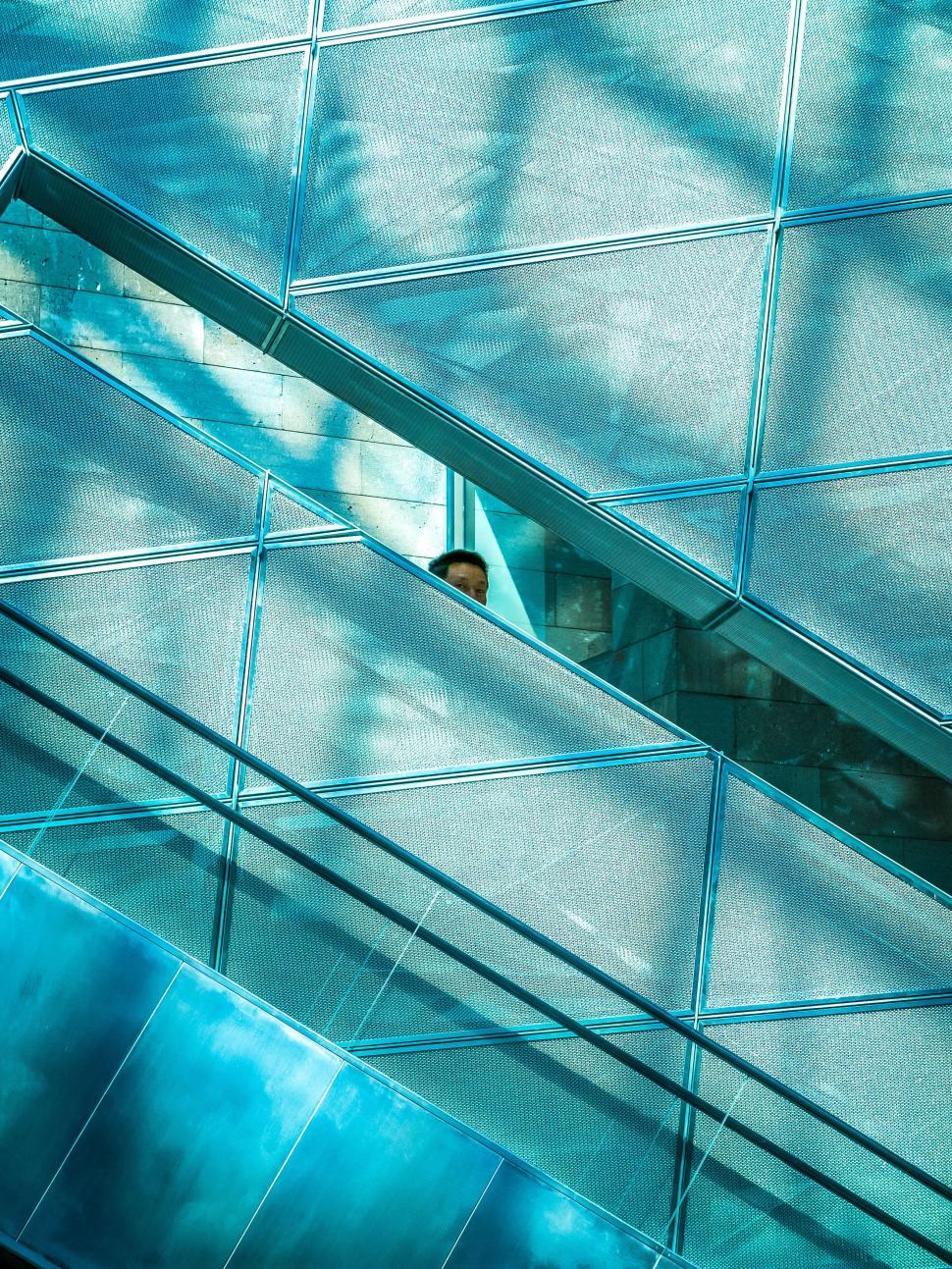 Free Image of Man Standing in Window of Building 