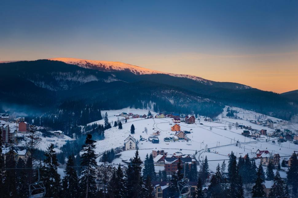 Free Image of Snow Covered Mountain With Village in Distance 