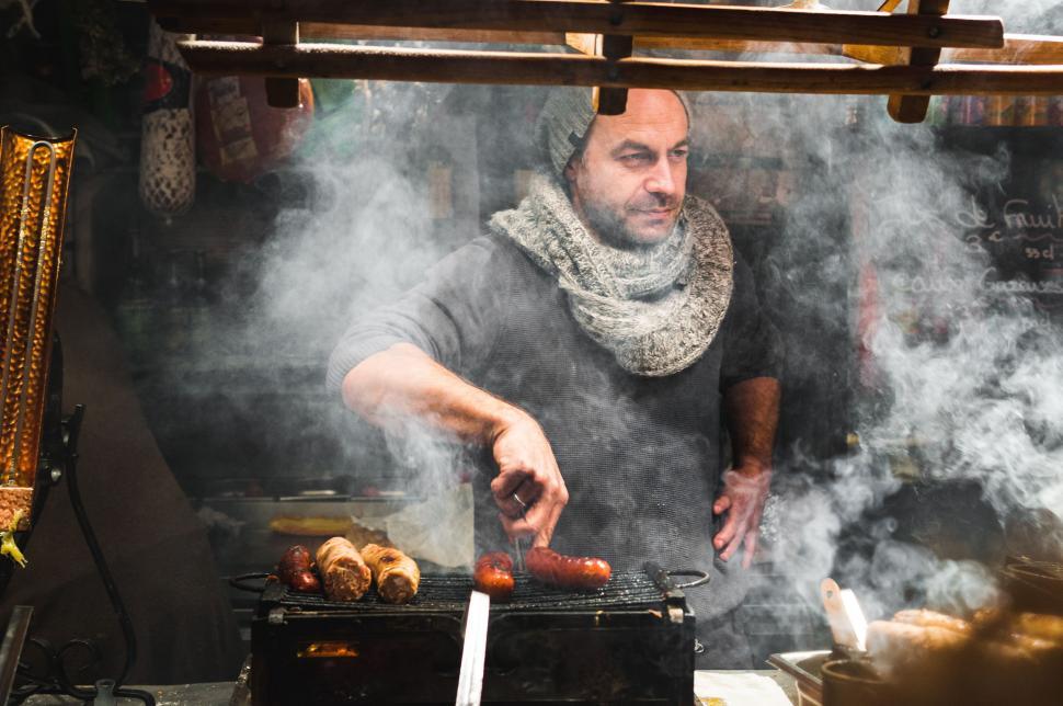 Free Image of Man Cooking Food on Top of a Grill 