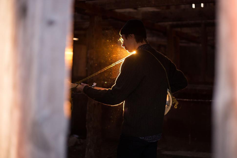 Free Image of Man Standing in Doorway With Light 