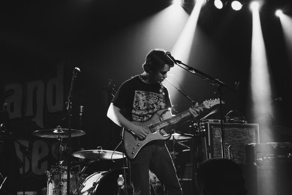 Free Image of Man Playing Guitar in Black and White 