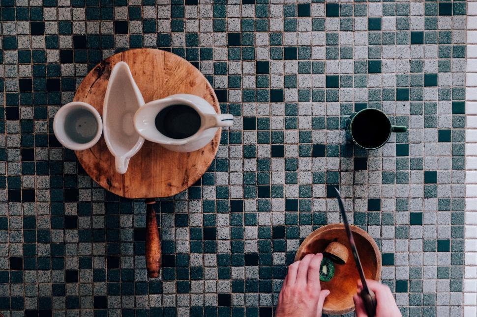 Free Image of Person Cutting Doughnut on Wooden Board 