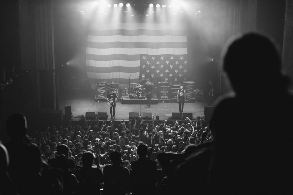 Free Image of Man Standing on Stage in Front of Crowd 