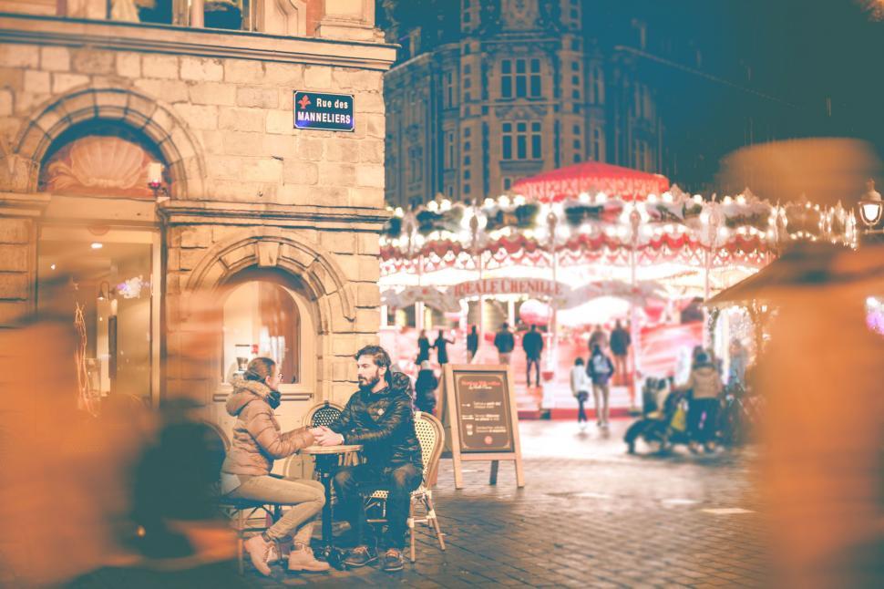 Free Image of Couple Sitting on Bench in Front of Building 