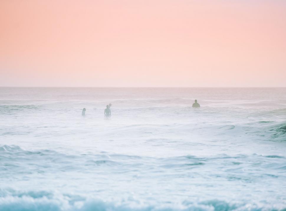 Free Image of Group of People Surfing in the Ocean 