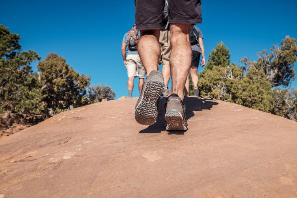 Free Image of Person Ascending Hill on Sunny Day 