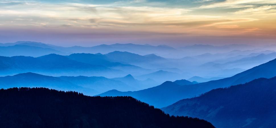 Free Image of Majestic Mountain Range Silhouetted Against Setting Sun 