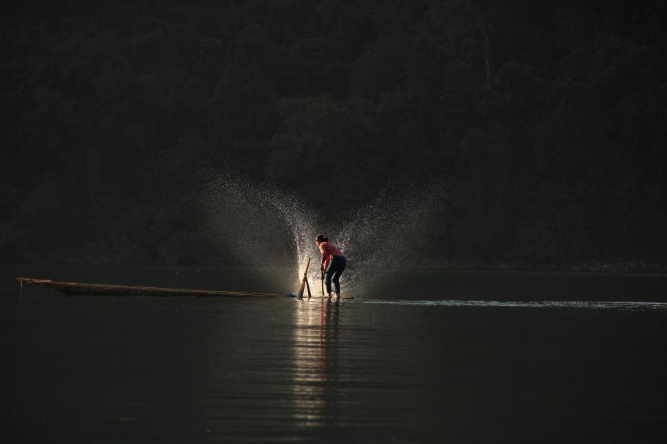 Free Image of Couple Standing in the Middle of a Body of Water 