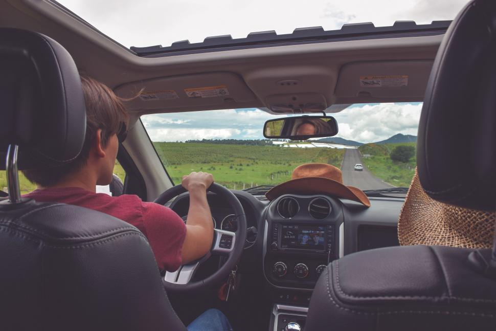 Free Image of Man Driving Car Down Country Road 