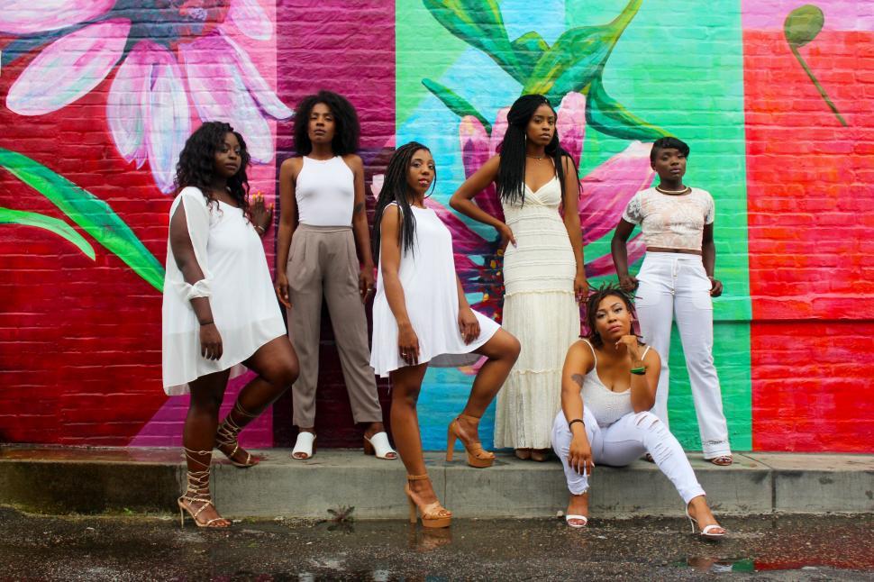 Free Image of Group of Women Standing in Front of Colorful Wall 