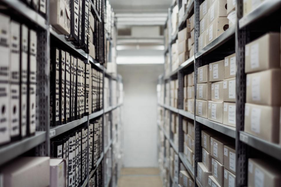 Free Image of Long Narrow Aisle Filled With Boxes 