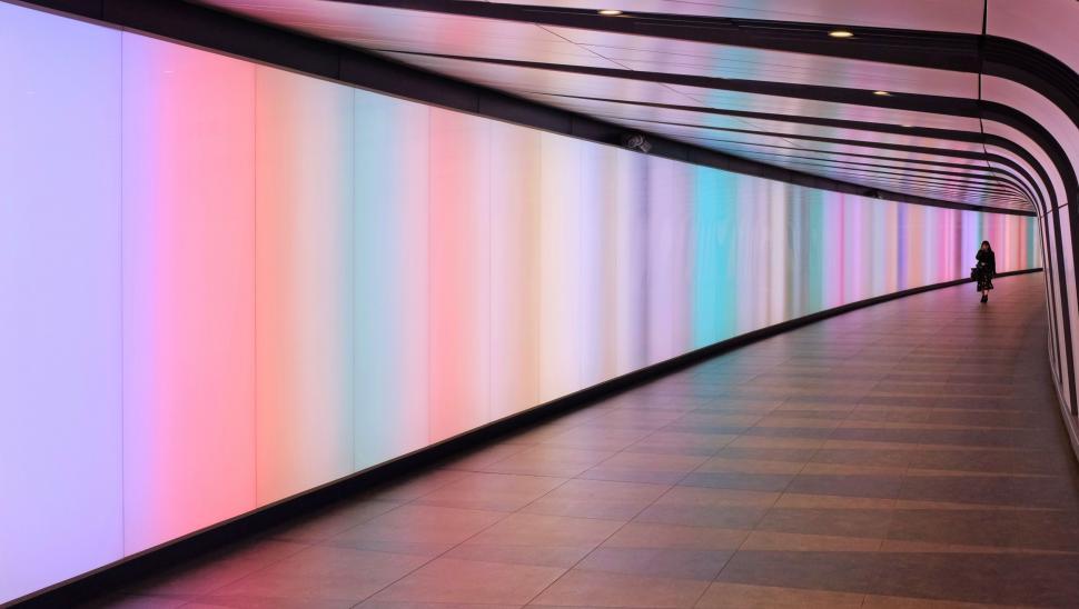 Free Image of Person Walking Down a Long Hallway 