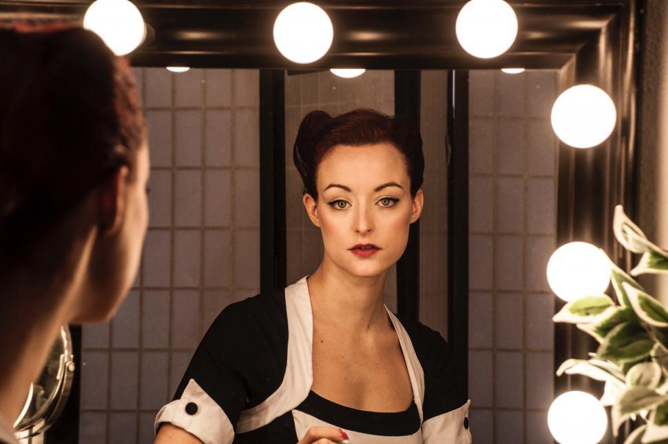 Free Image of Woman Standing in Front of Bathroom Mirror 