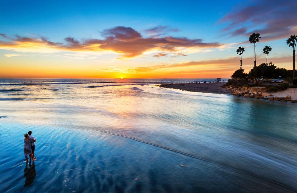 Free Image of Man Standing on Top of Beach Next to Ocean 