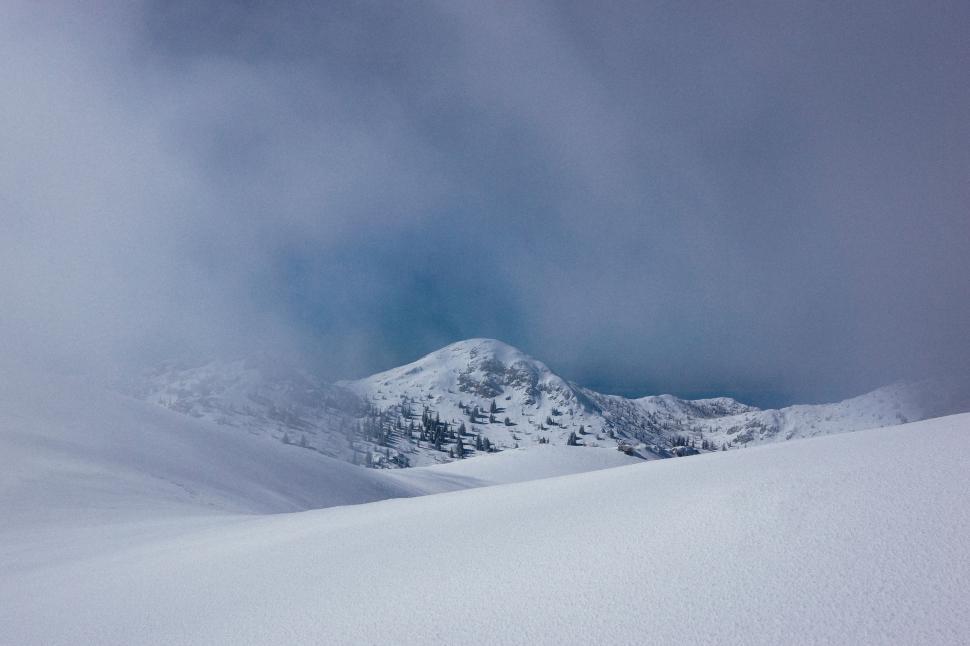 Free Image of Snowboarder Descending Snowy Hill 