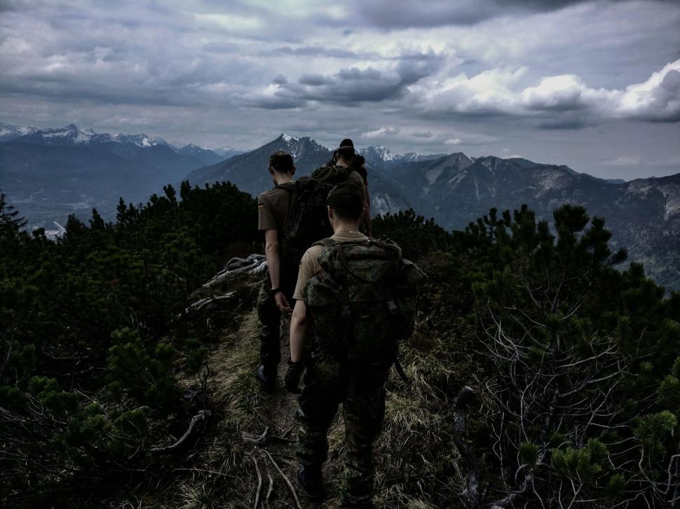 Free Image of Group of People Walking Up a Hill 