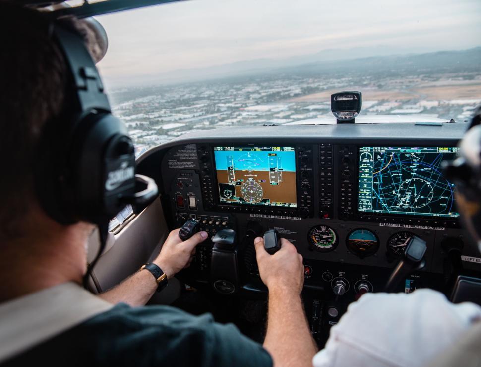 Free Image of Man Flying Small Airplane Over City 