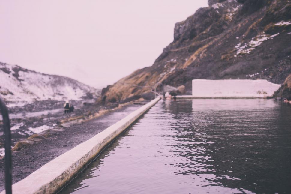 Free Image of Man Standing on Dock by Water 