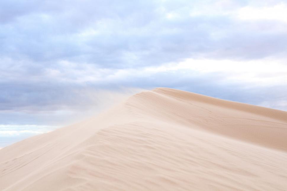 Free Image of Person Standing on Top of a Sand Dune 