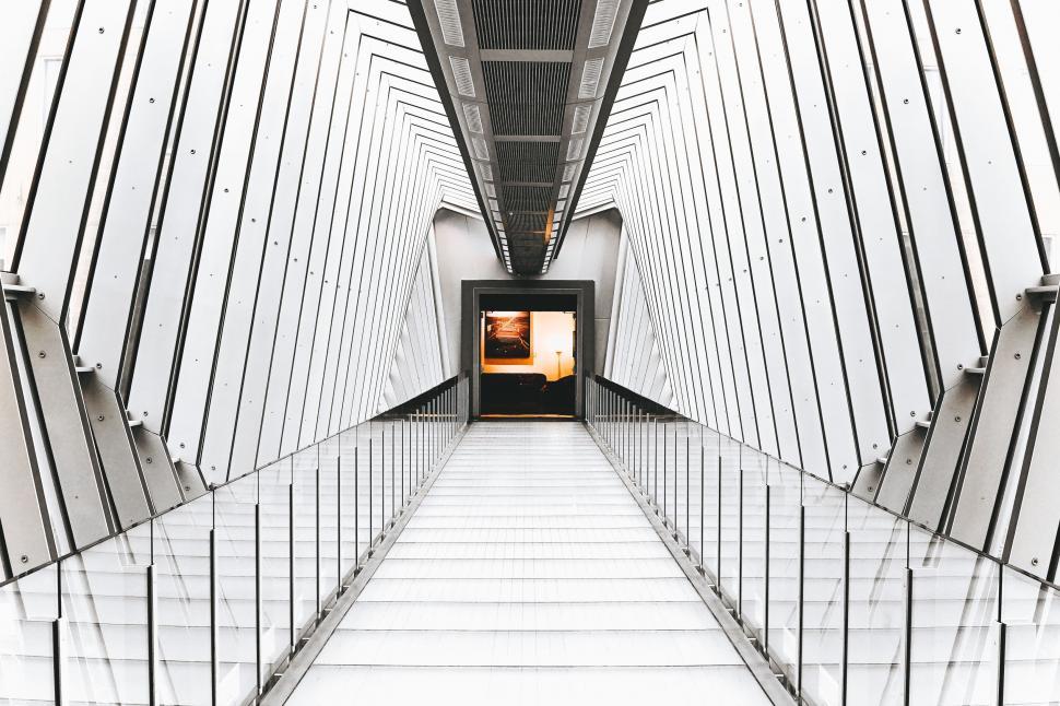 Free Image of Long Hallway With Stairs Leading to Door 
