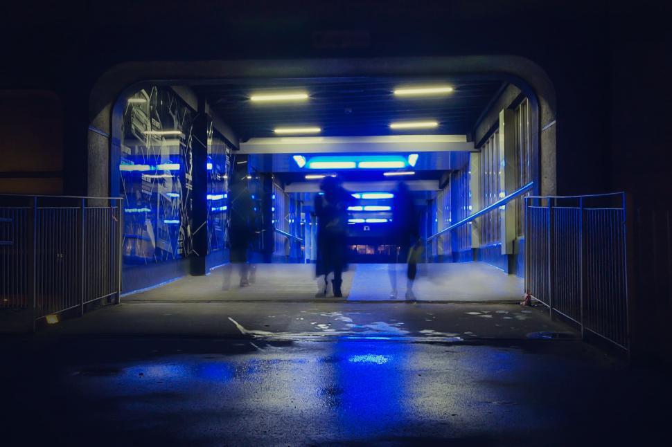 Free Image of Couple Walking Down Street at Night 