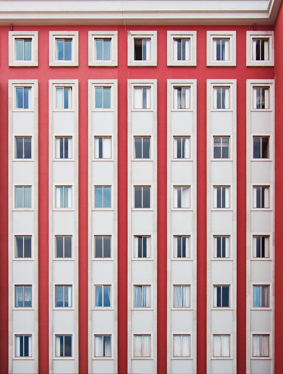 Free Image of Red and White Building With Many Windows 