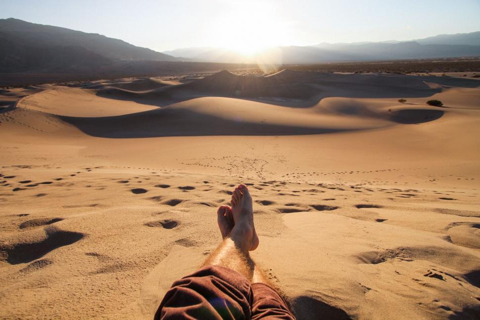 Free Image of Person Laying on Sandy Beach 