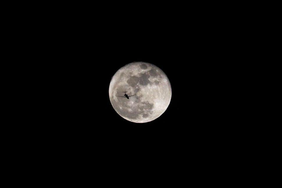 Free Image of Plane Flying in Sky With Full Moon 
