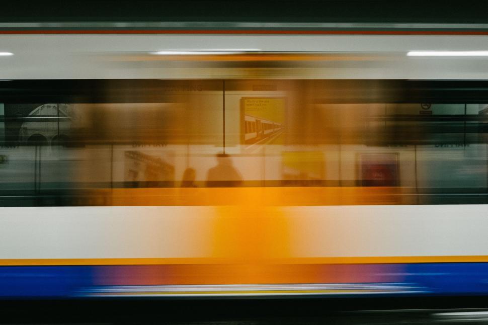 Free Image of Blurry Photo of Train Moving Through City 
