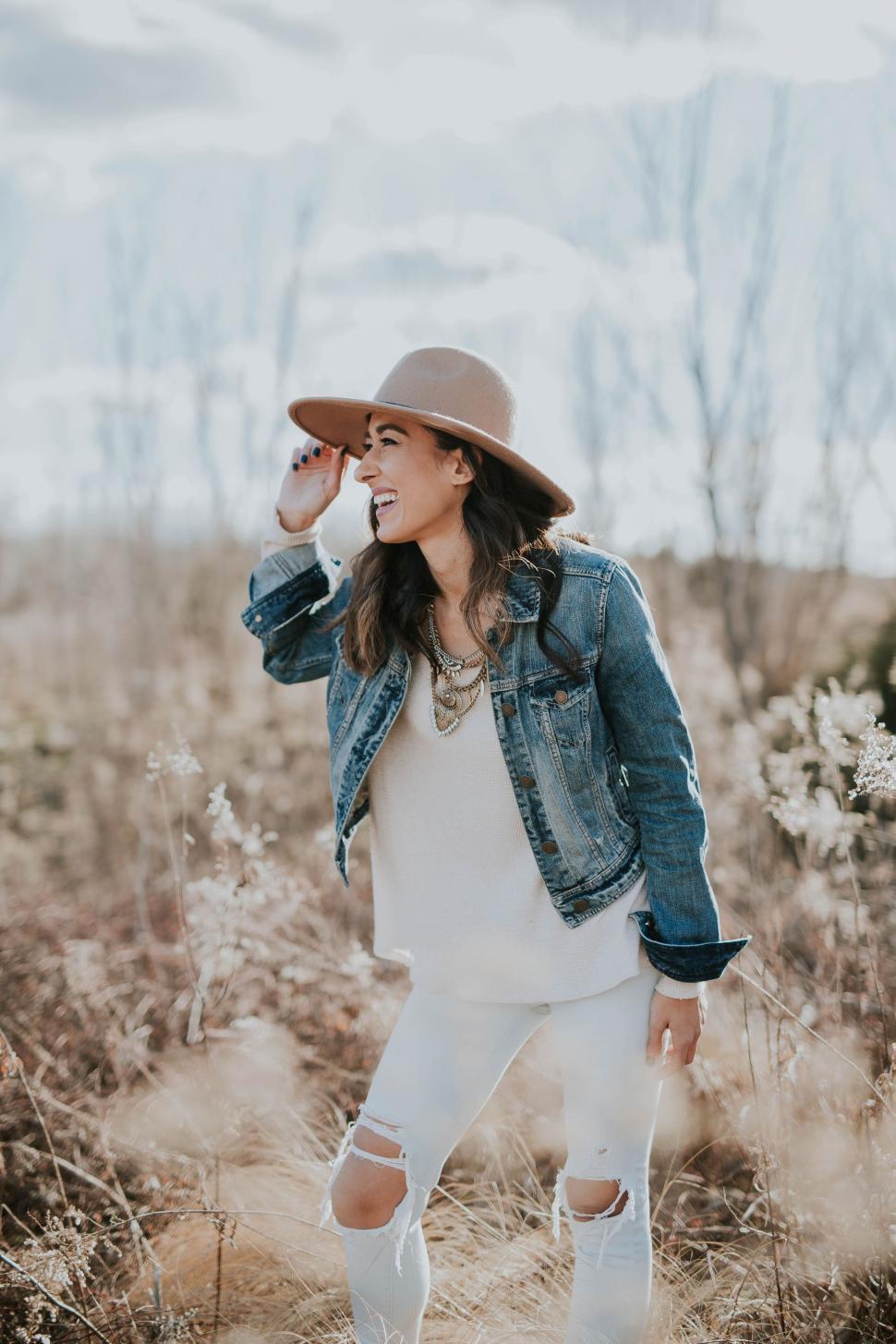 Free Image of Woman Standing in a Field Wearing a Hat 