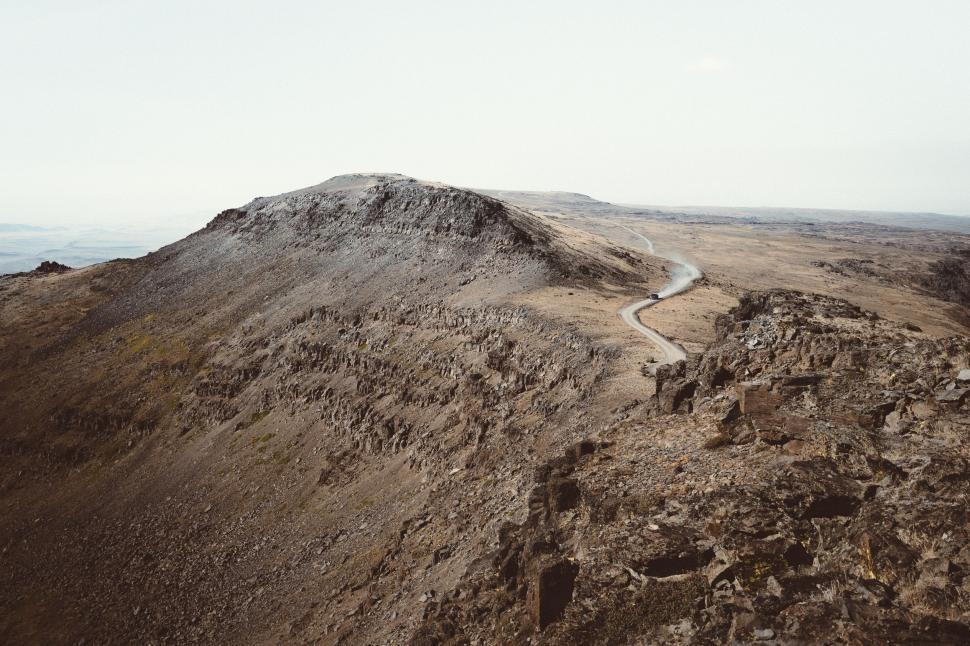 Free Image of Dirt Hill With River Running Through It 