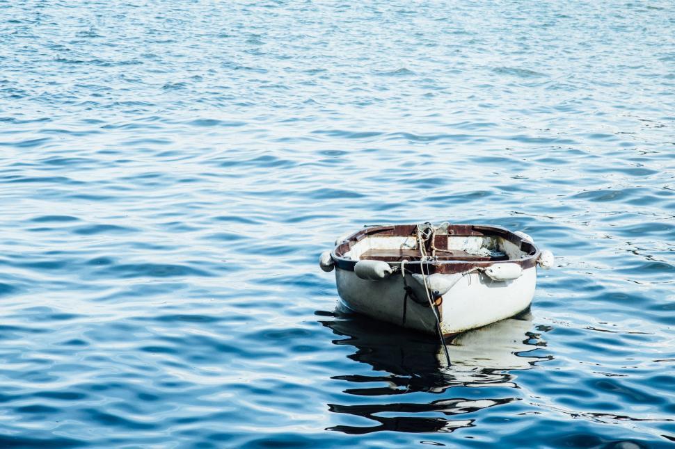 Free Image of Small Boat Floating on Body of Water 