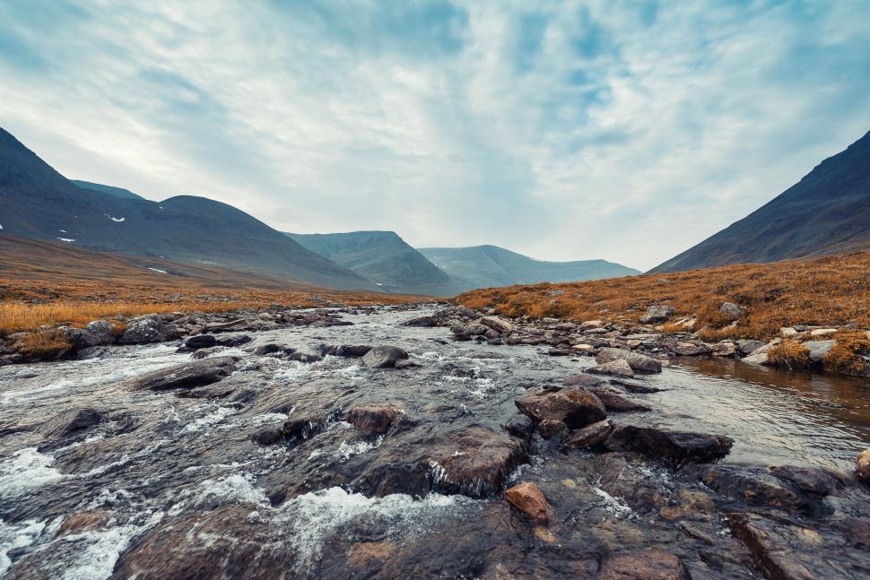 Free Image of River Flowing Through Valley Surrounded by Mountains 