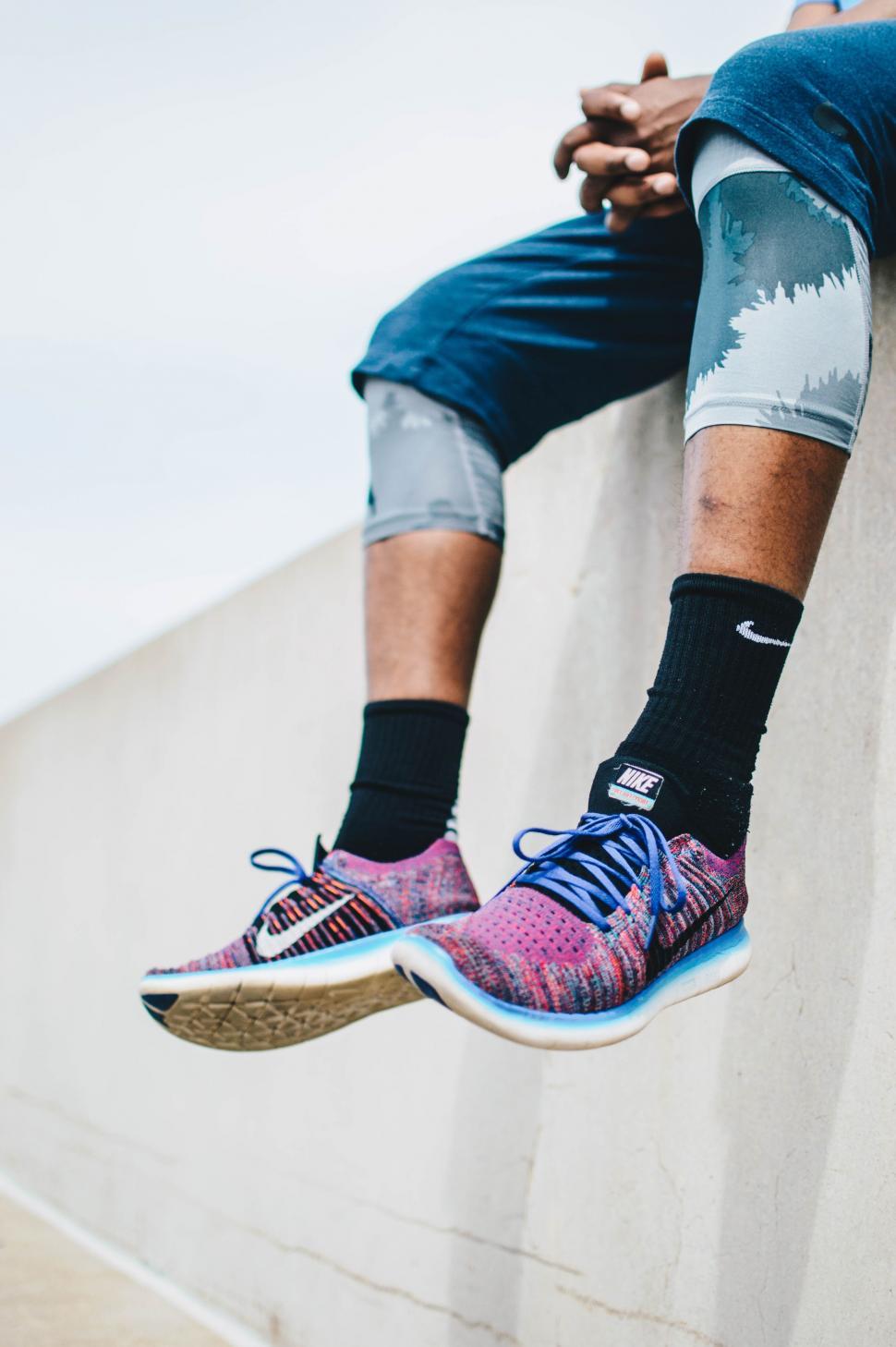 Free Image of Person Sitting on Ledge With Feet Up 