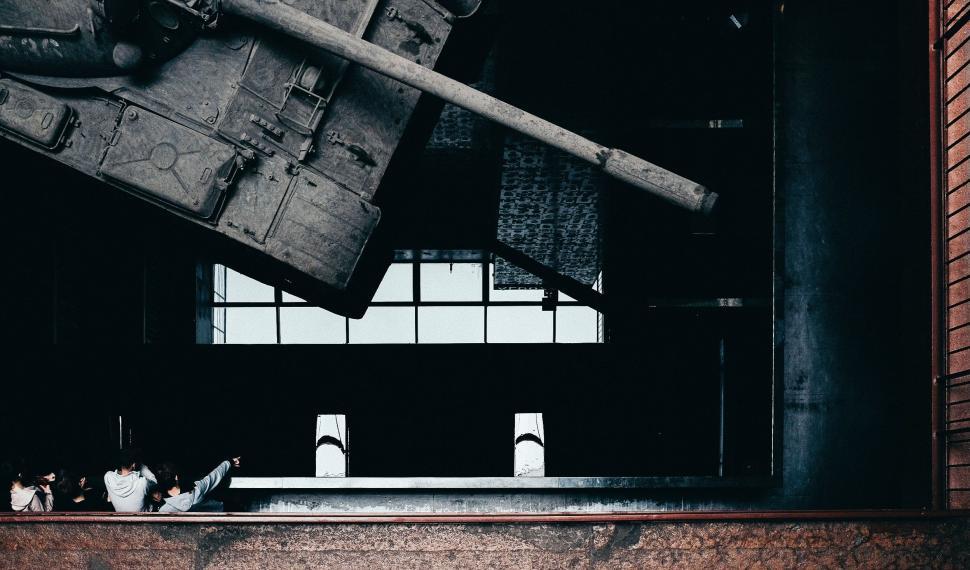 Free Image of Large Piece of Luggage Hanging From Side of Building 