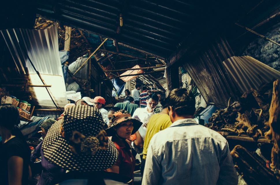 Free Image of Group of People Standing Around Wooden Structure 