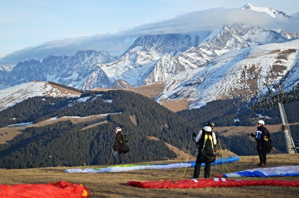 Free Image of Group of People Standing on Top of Snow Covered Slope 