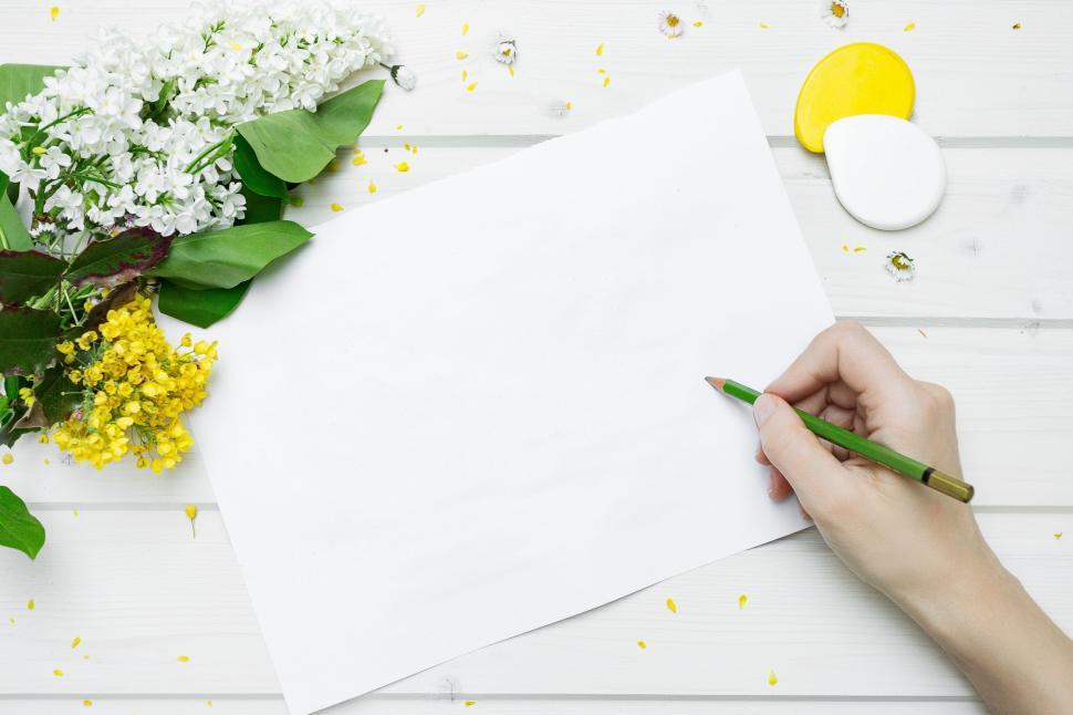 Free Image of Person Writing on Piece of Paper 