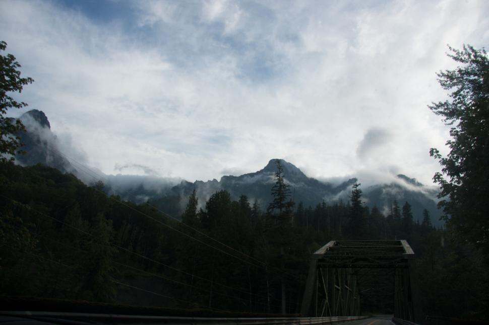 Free Image of Road Passing Through Forest Under Cloudy Sky 