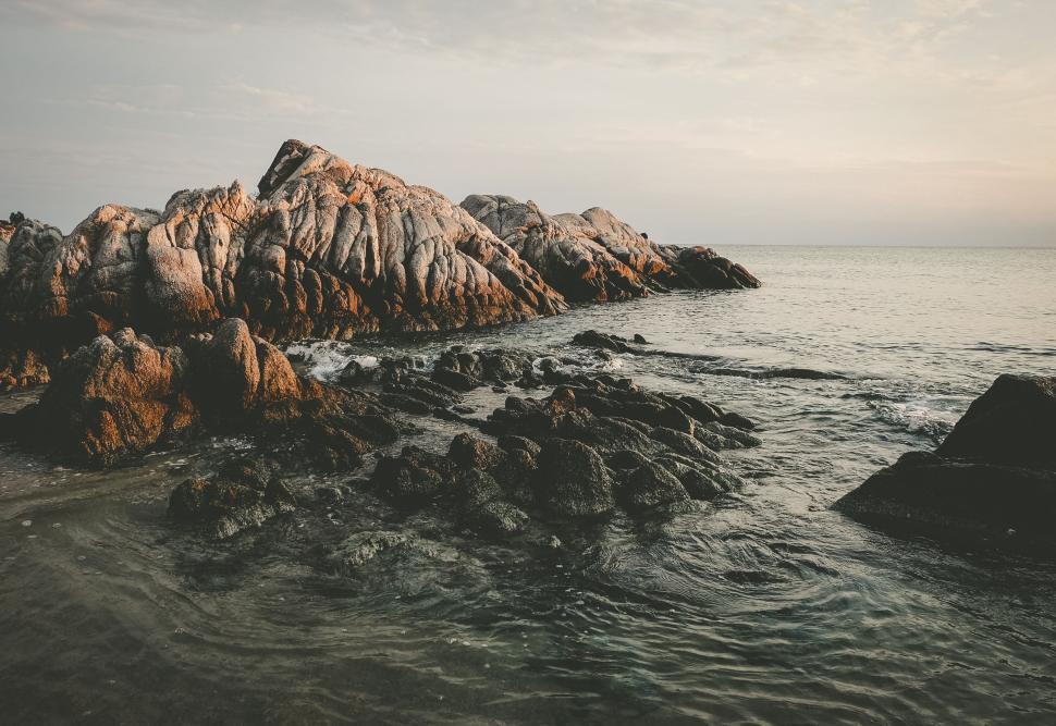 Free Image of Rock Formation Surrounded by Water 