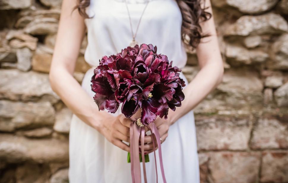Free Image of Woman in White Dress Holding Bouquet of Flowers 