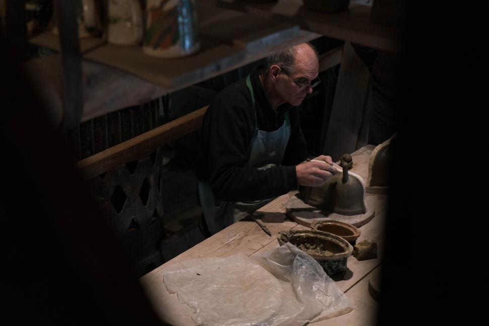 Free Image of Man Sitting at Table Working on Project 