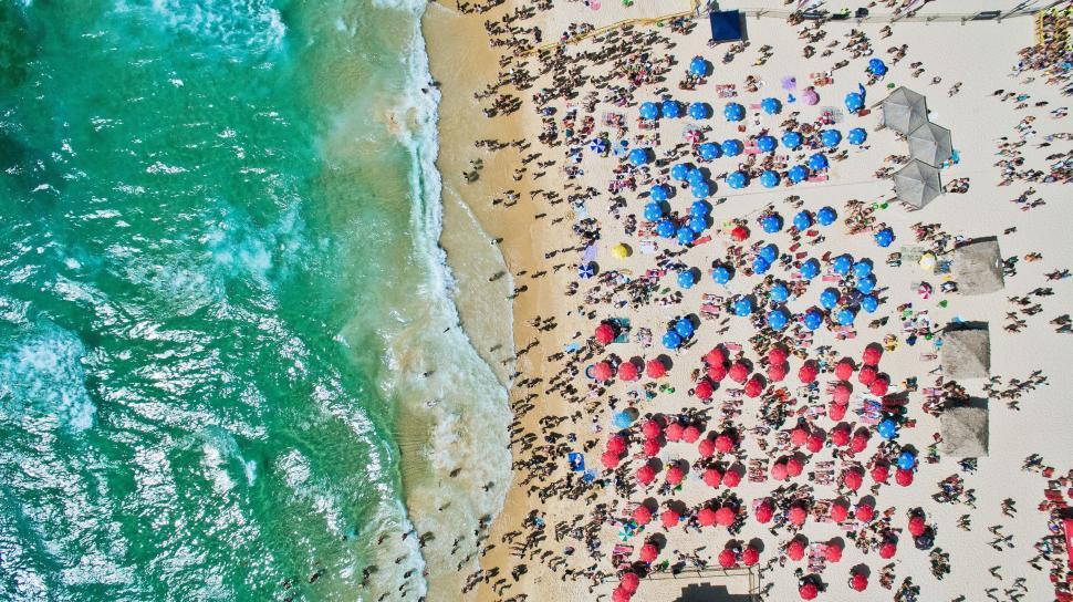 Free Image of Aerial View of Beach With Many Umbrellas 